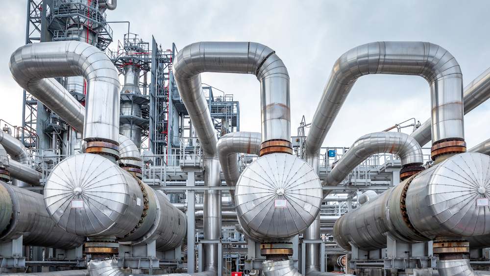 European refinery buyers European refinery facility for sale featuring distillation units and storage tanks.